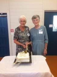 Life members Bev Doohand (L) and Anne Lanigan (R) cut the Anniversary Cake